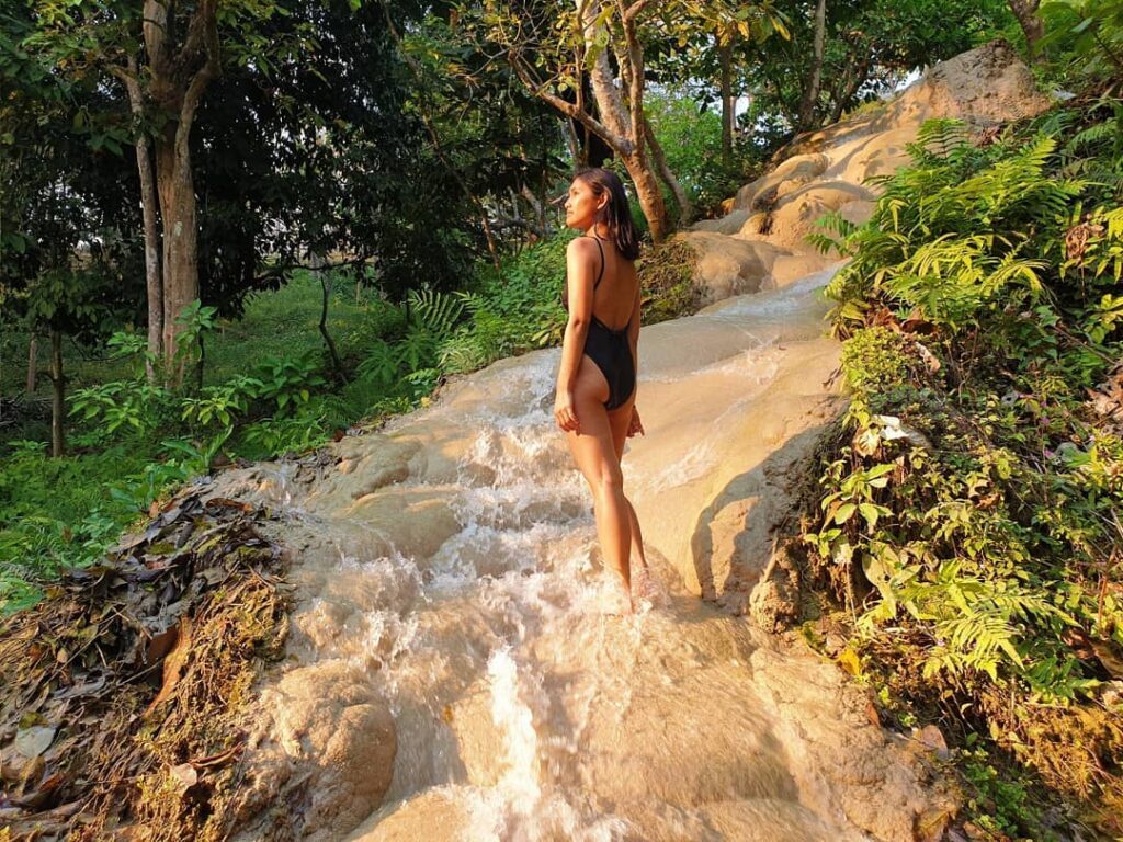 woman standing on sticky bua thong waterfall