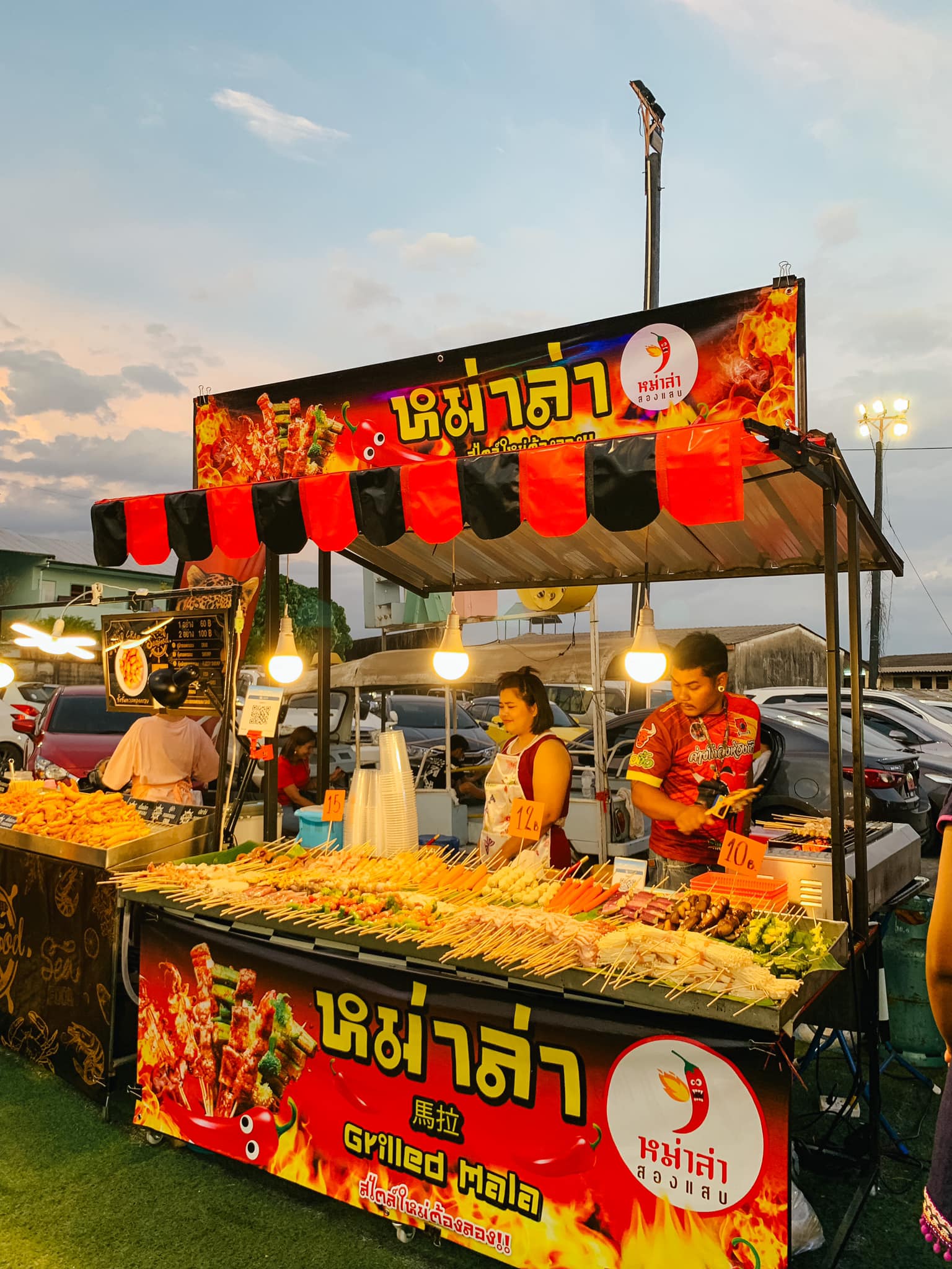 A grilled Mala food cart selling delicious and spicy meats inside Chillva Market in Southern Thailand.