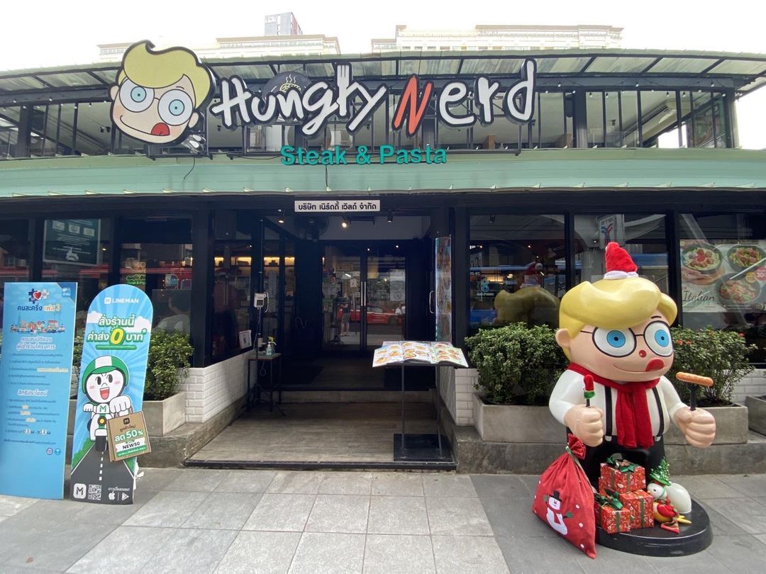 The storefront of Hungry Nerd near BTS Ratchathewi with their mascot. 