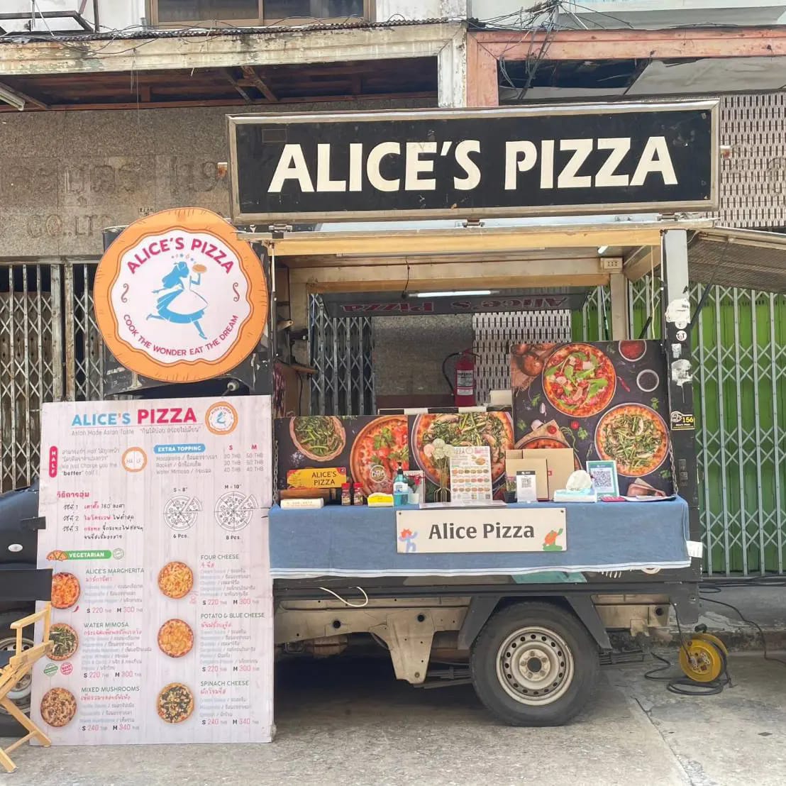 The Alice's Pizza food truck just about to open in front of old Bangkok shophouses. 