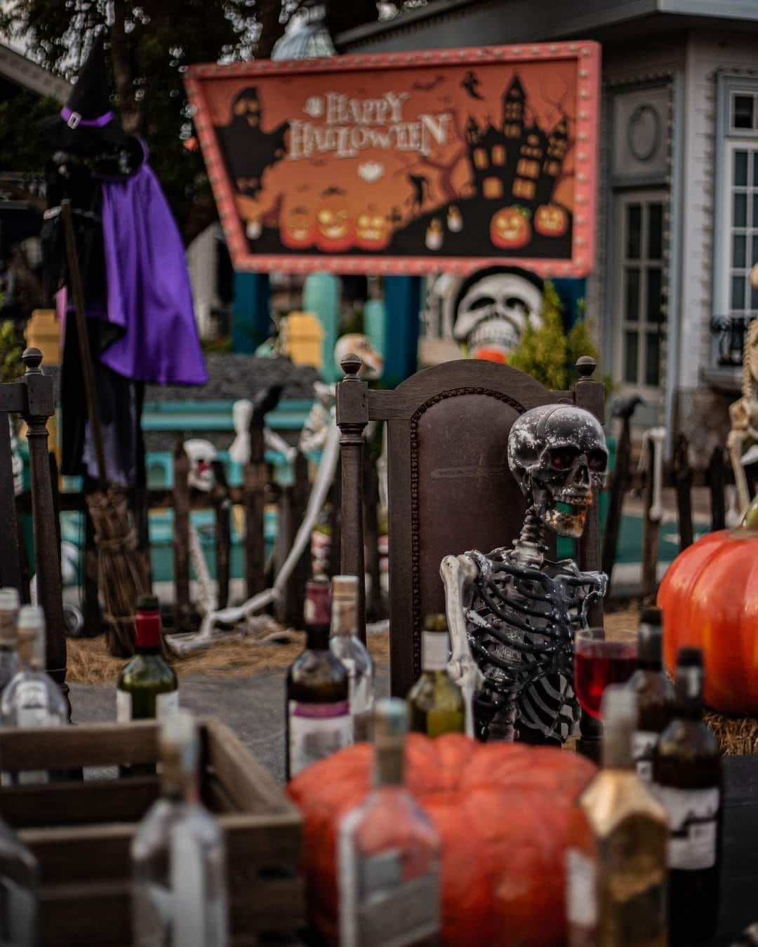 Chocolate Ville decorated with Halloween-themed props including carved pumpkins and skeletons.