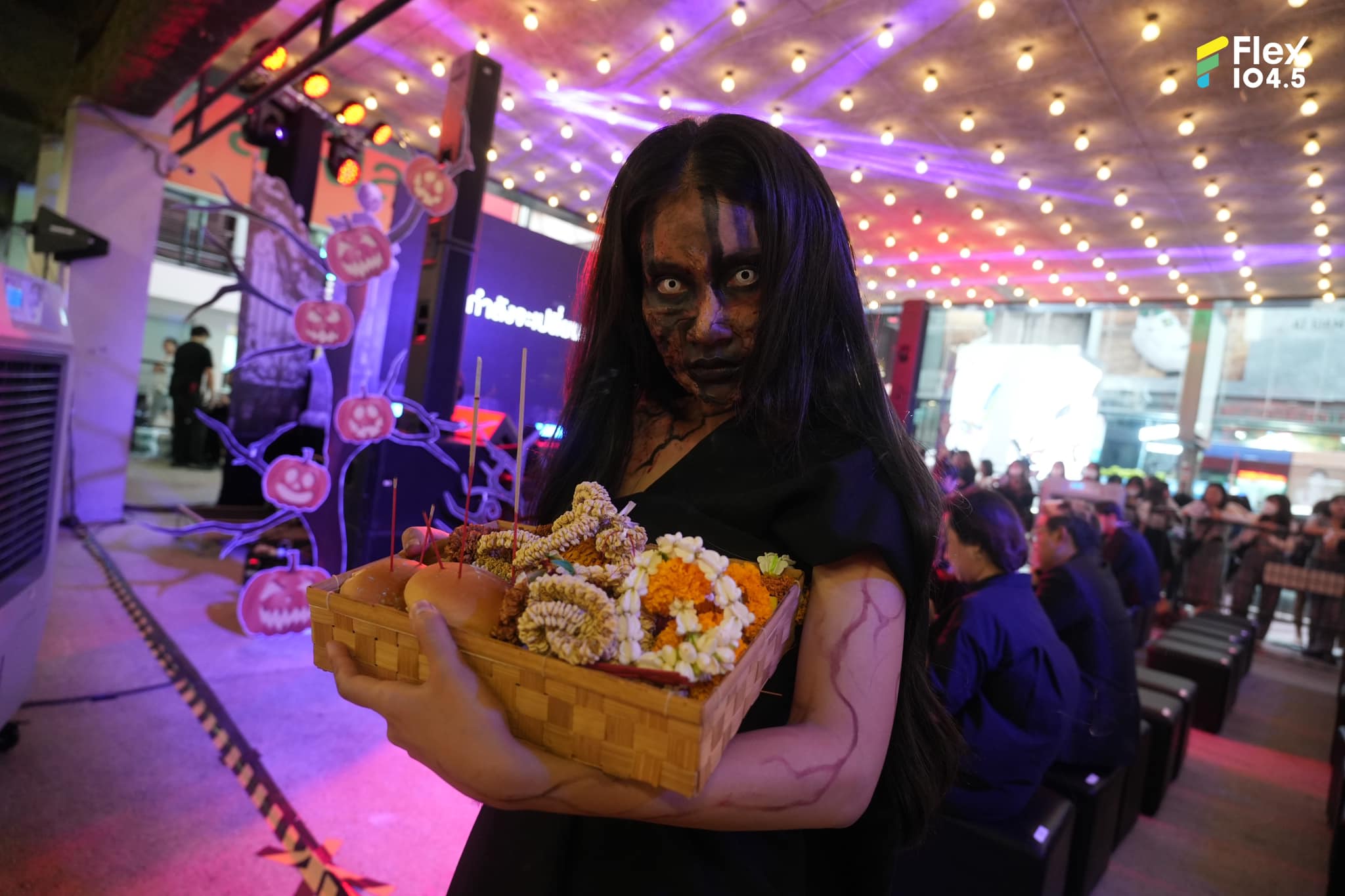 A woman dressed as a scary ghost promoting Siam Halloween. 