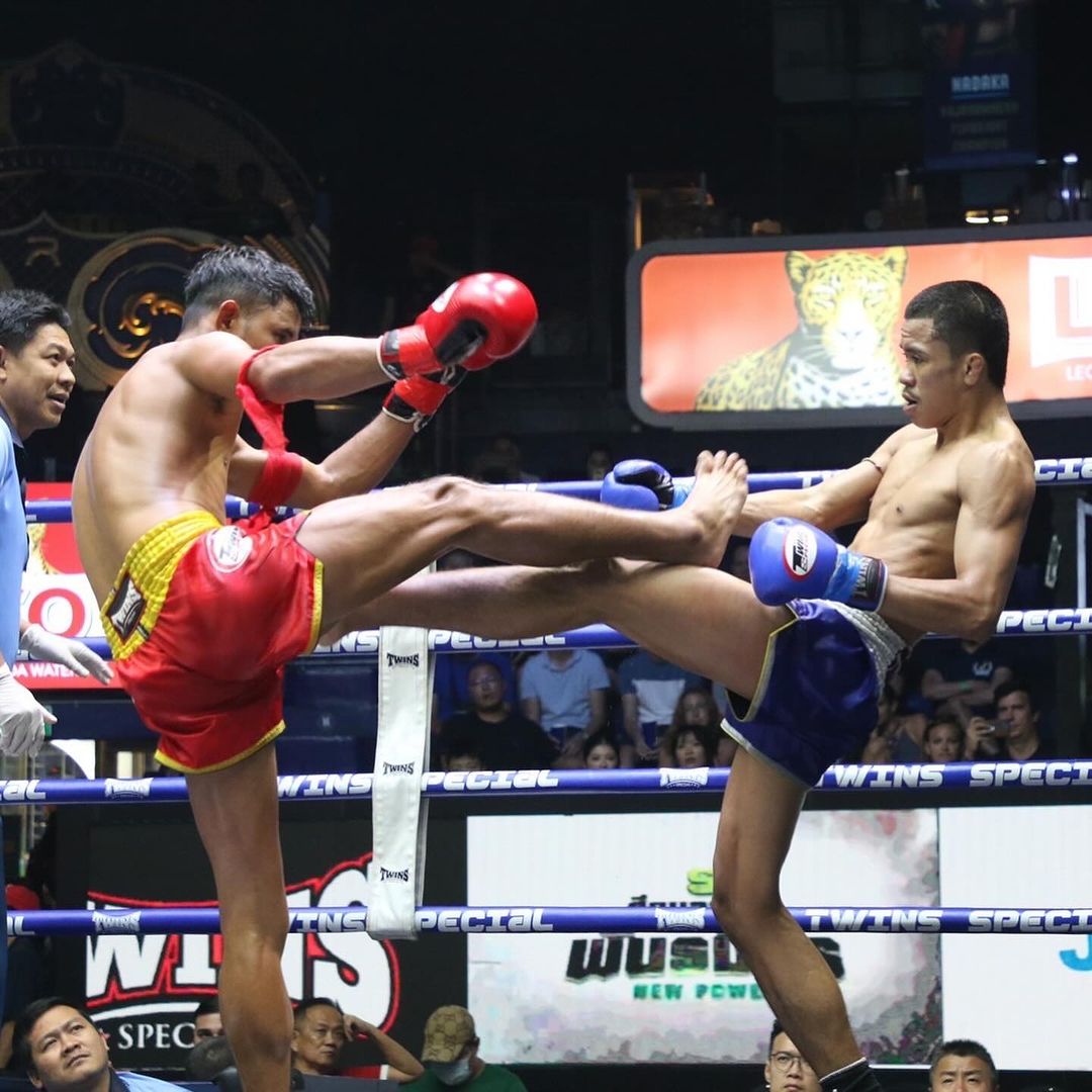 Two Muay Thai boxers duking it out on stage at Rajadamnern Stadium