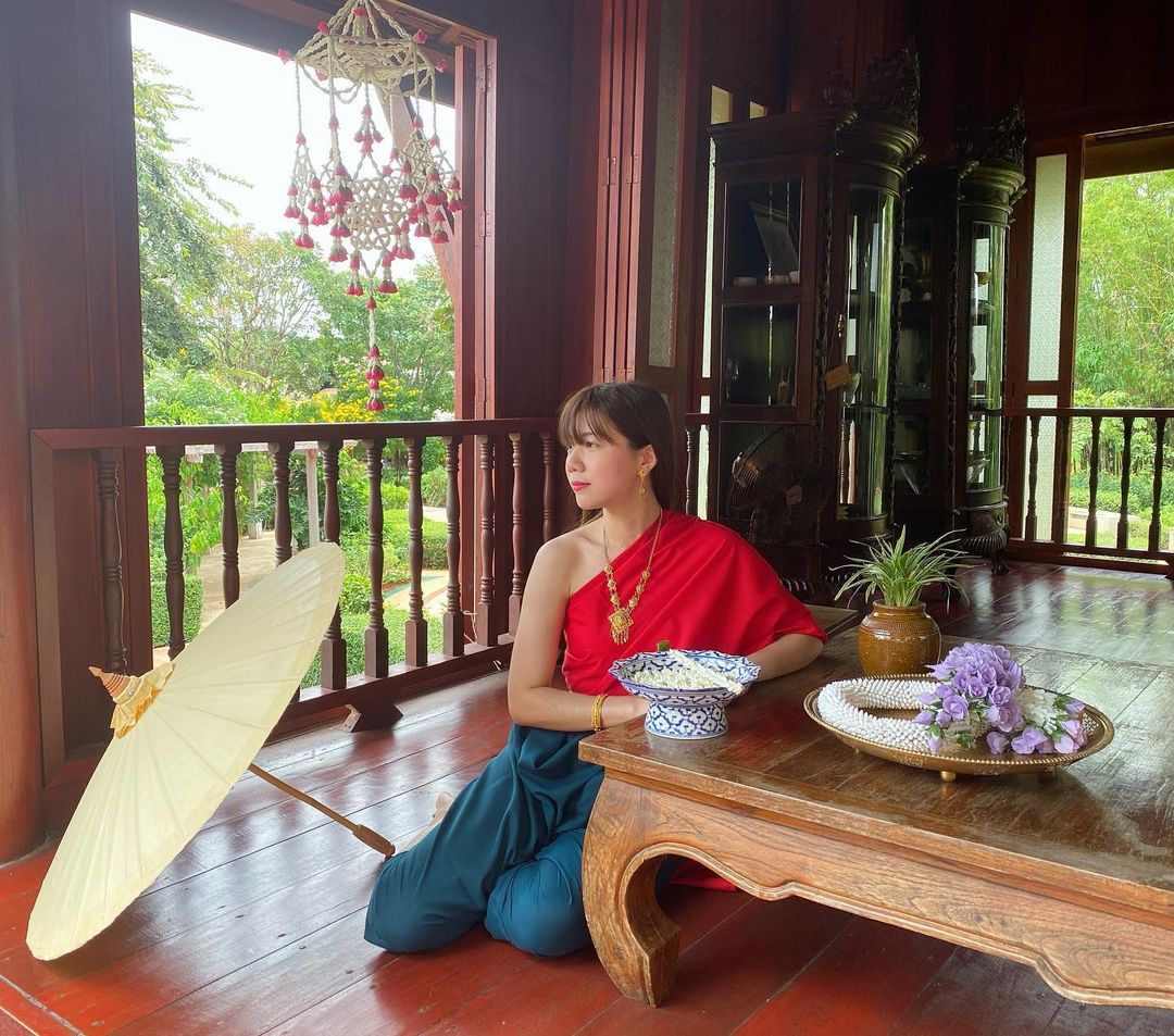 A woman posing for the camera in a traditional Thai costume at Mallika R.E 124